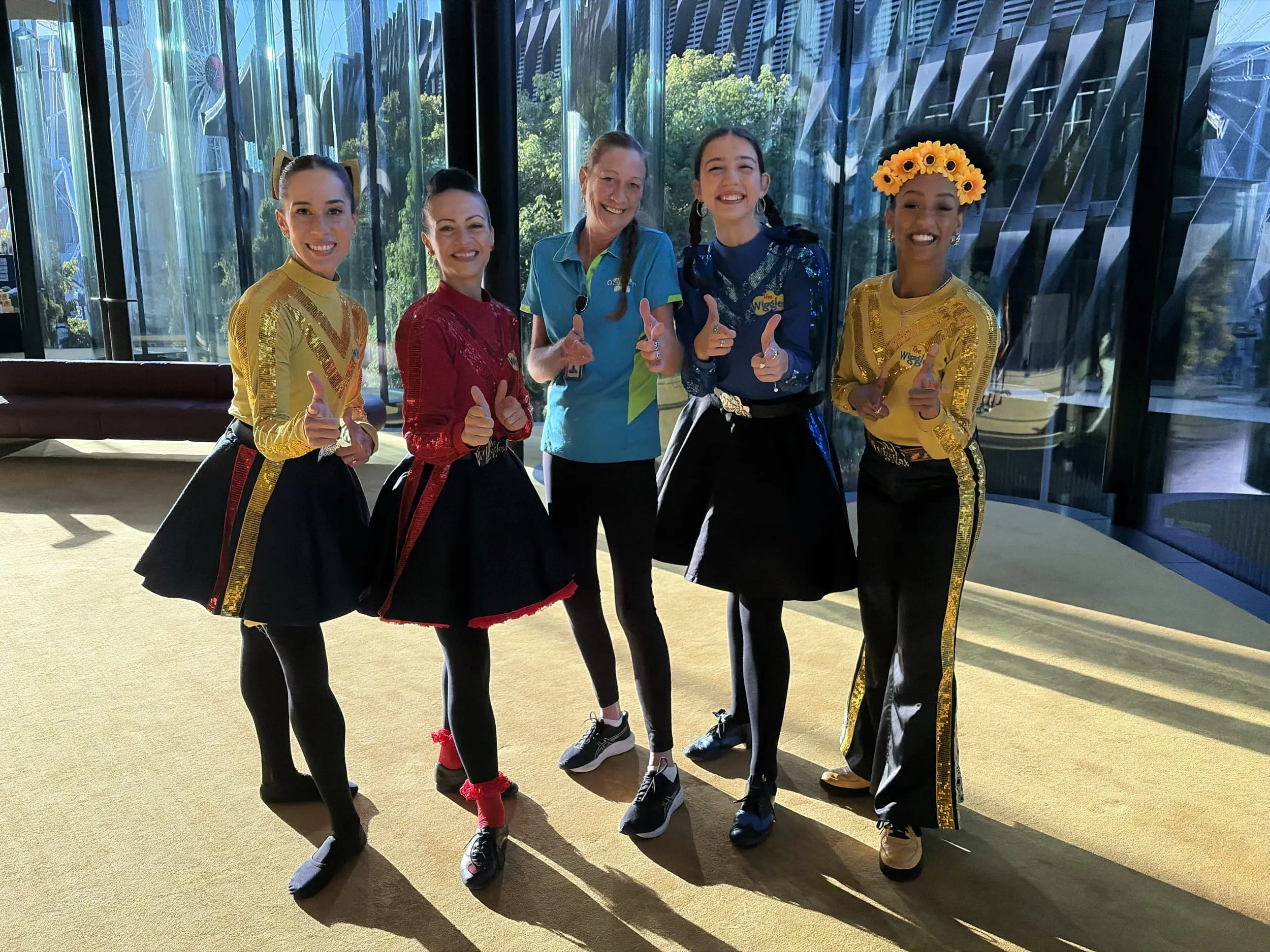 Ozifresh staff member posing with The Wiggles cast members during a promotional event