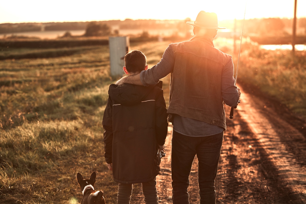 Father and son walking in a Montana farm field