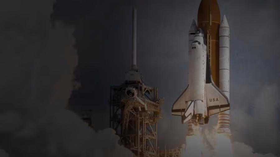 Space shuttle launching with flames and smoke beneath it near the launch tower.