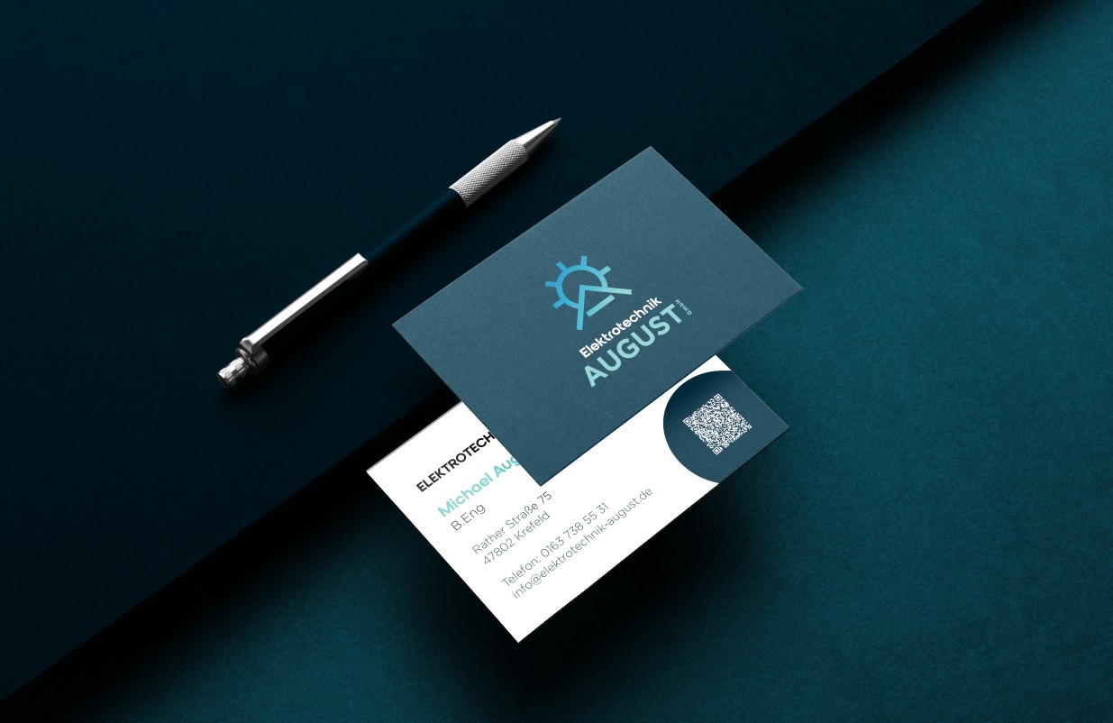 Minimalist branding mockup with business cards, dot grid paper, and a pen on a dark surface.