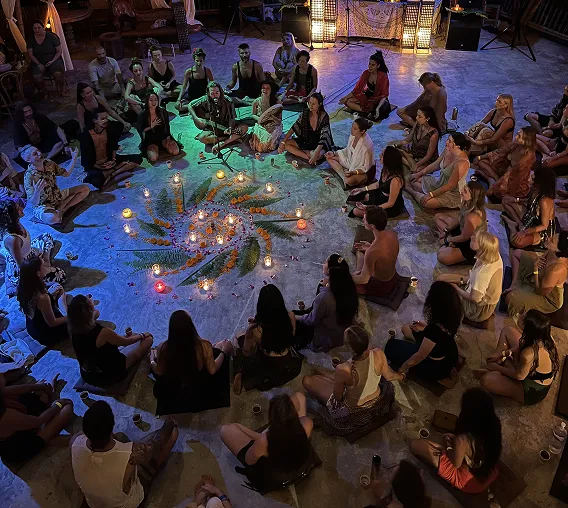 Evening ceremony with candles and flower mandala at Shivari