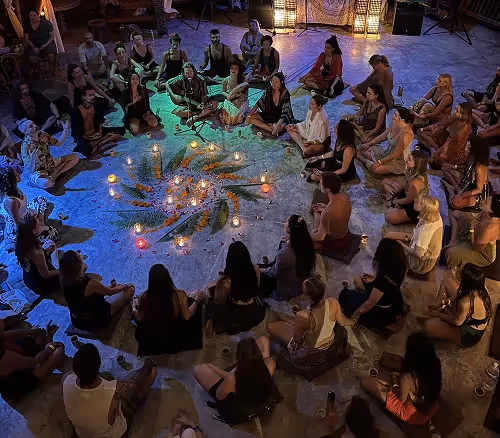 Evening ceremony with candles and flower mandala at Shivari