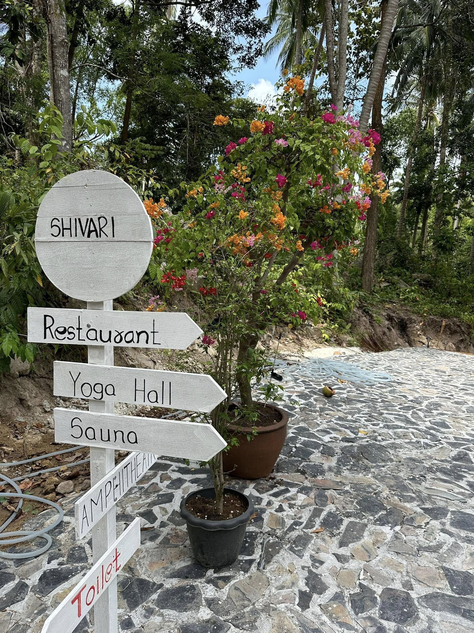 Shivari directional signpost pointing to restaurant, yoga hall, and sauna