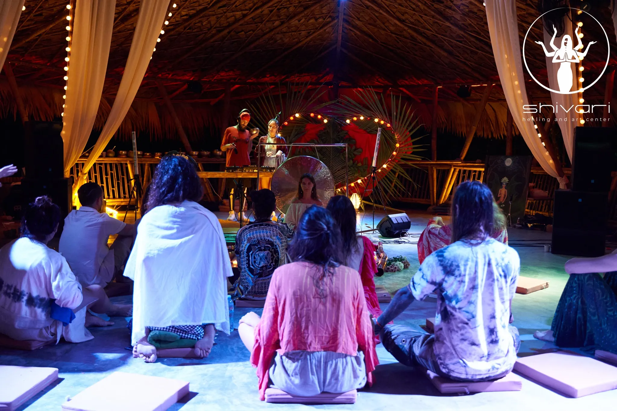 Event space with thatched roof hosting group dance gathering