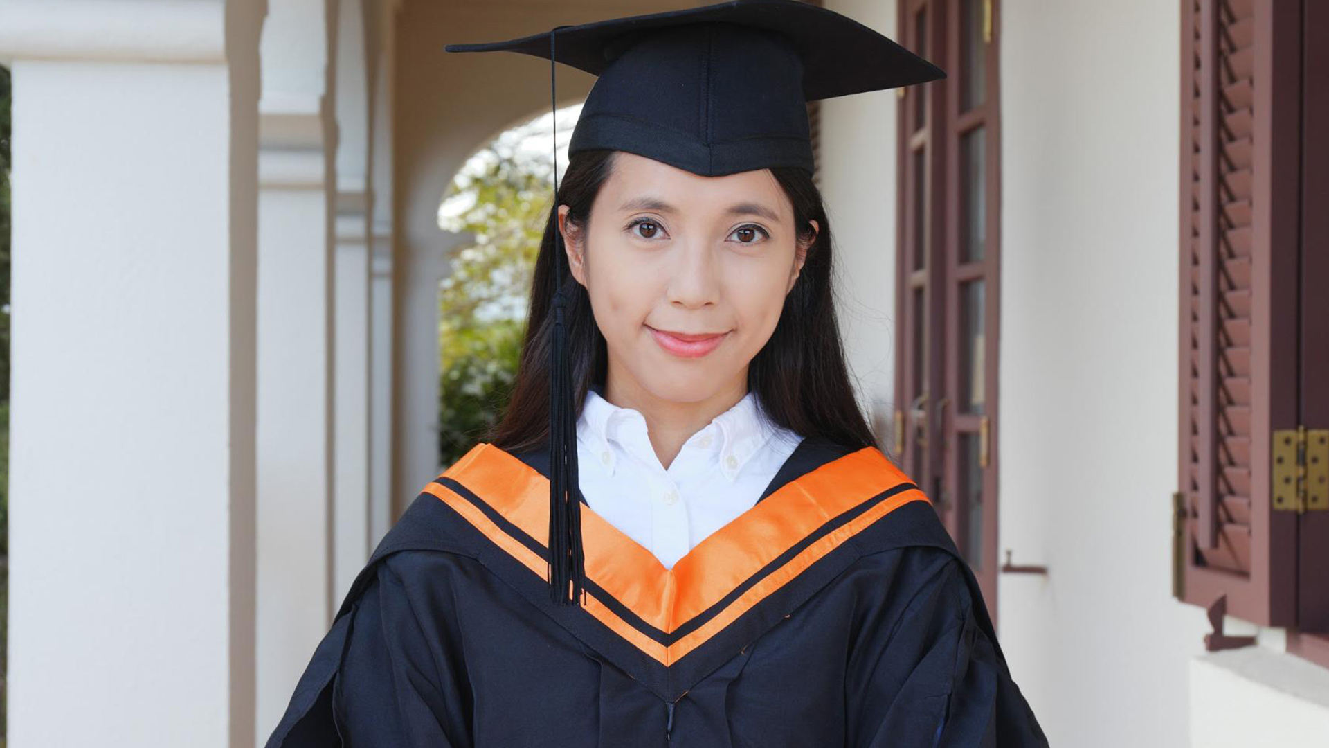 A graduate smiling