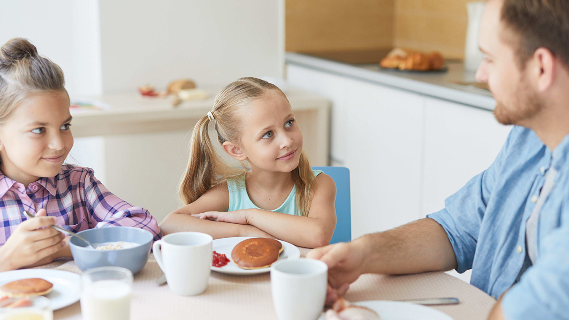 Family at a kitchen table having a breakfast