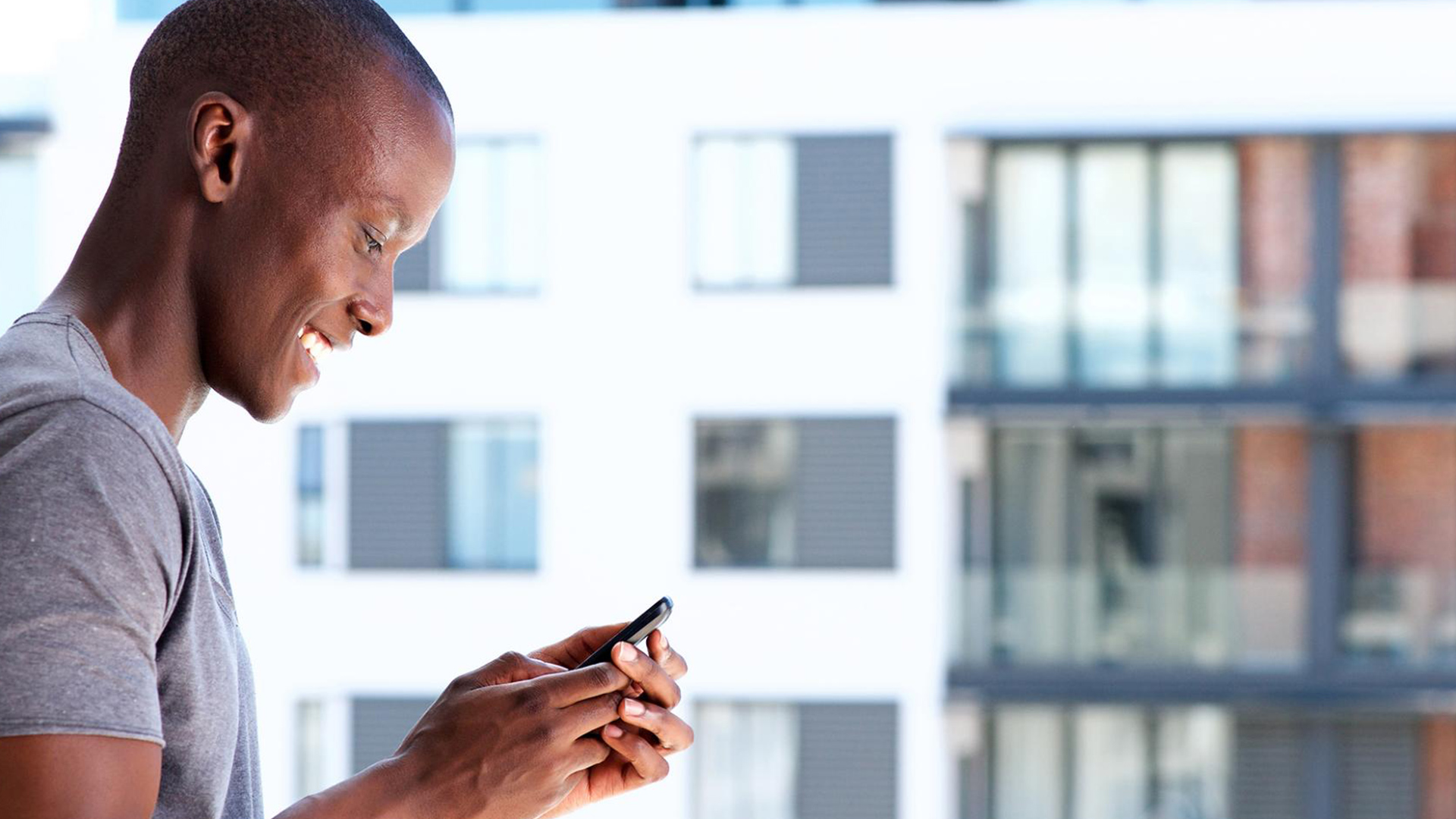 Happy man looking at his phone and smiling
