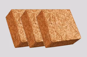 Three compressed coconut coir fiber blocks stacked side by side on a light gray background.