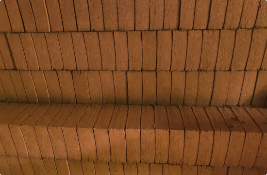 Stacks of rectangular brown coir blocks neatly arranged in rows.
