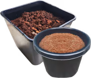 Two black containers filled with reddish-brown soil or mulch, one larger rectangular and one smaller round.