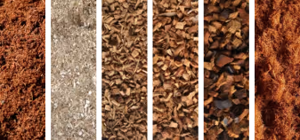 Close-up of six vertical samples of different types and textures of mulch or bark chips arranged side by side.