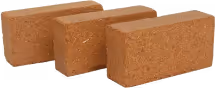 Three rectangular coir fiber bricks stacked together.