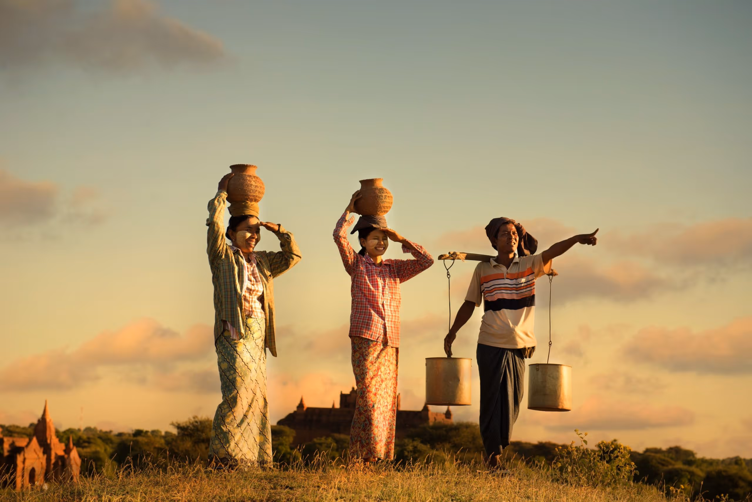 Women carrying water and grain on their heads