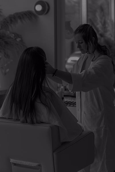 Beauty specialist working with a client in salon