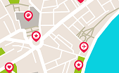 City map segment showing streets, buildings, water body, and various location markers for medical services.