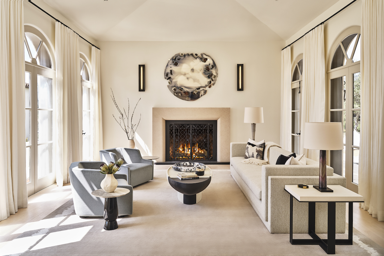 Bright luxury sitting room featuring complete home renovation with fireplace upgrade, custom furnishings, and modern open design.