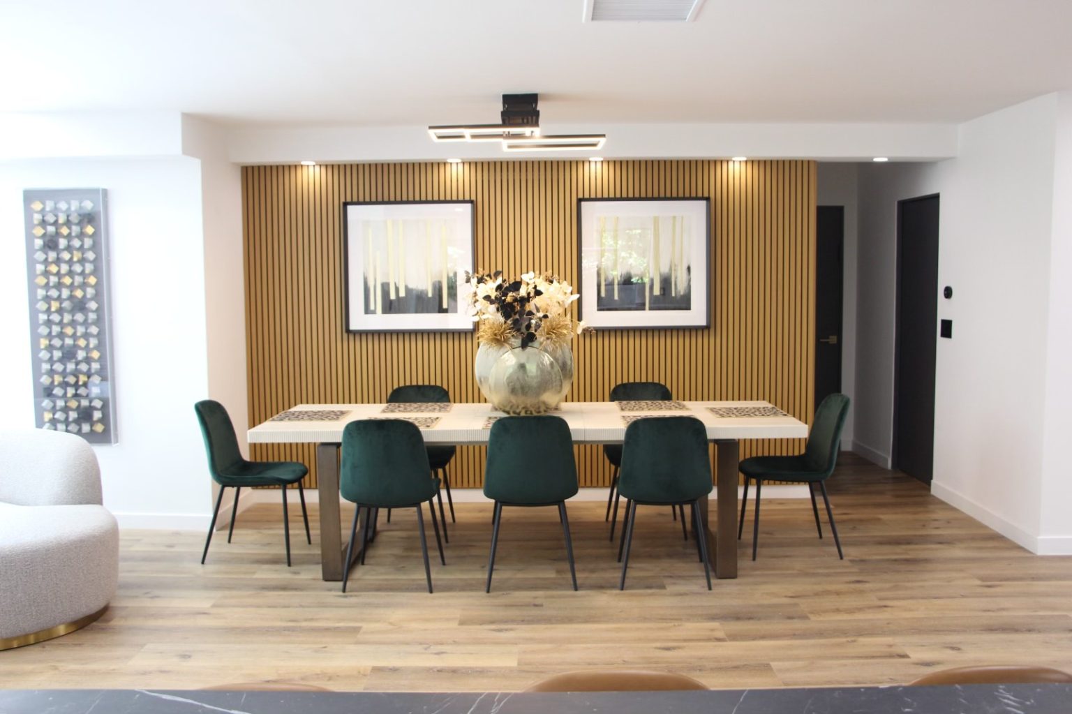 Modern dining area showcasing full home remodeling in Los Angeles with custom wood accent wall, updated flooring, and contemporary finishes