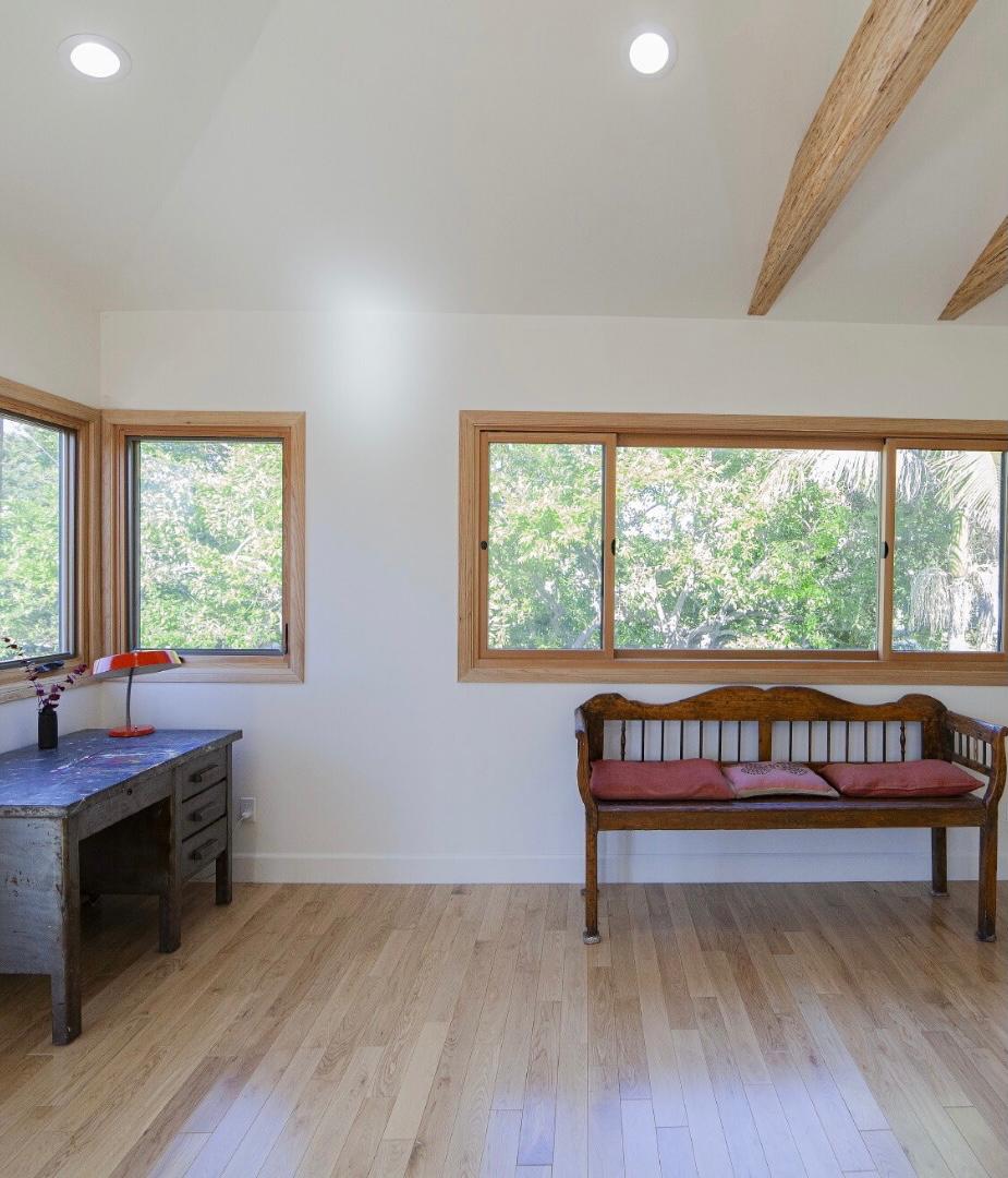 Detached ADU interior Los Angeles with vaulted ceiling, exposed beams and large windows