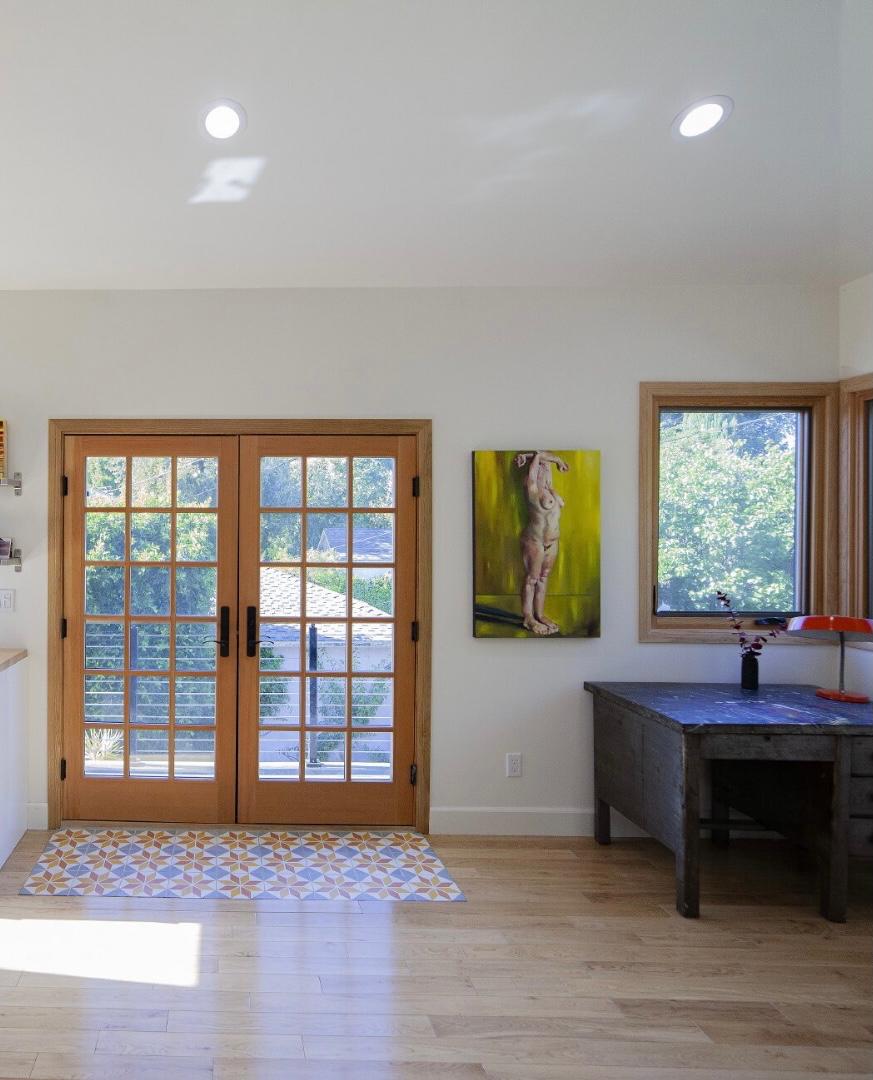 Garage conversion ADU Los Angeles with French doors, recessed lighting and hardwood flooring