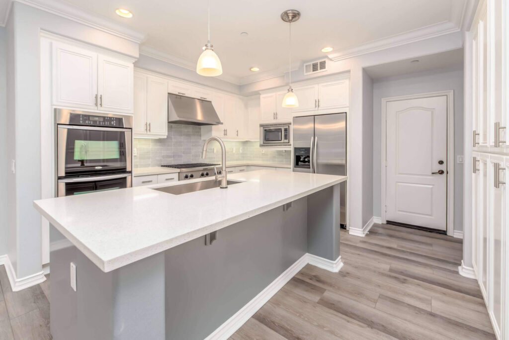 Kitchen remodel Woodland Hills with modern white cabinets, granite countertops and recessed lighting