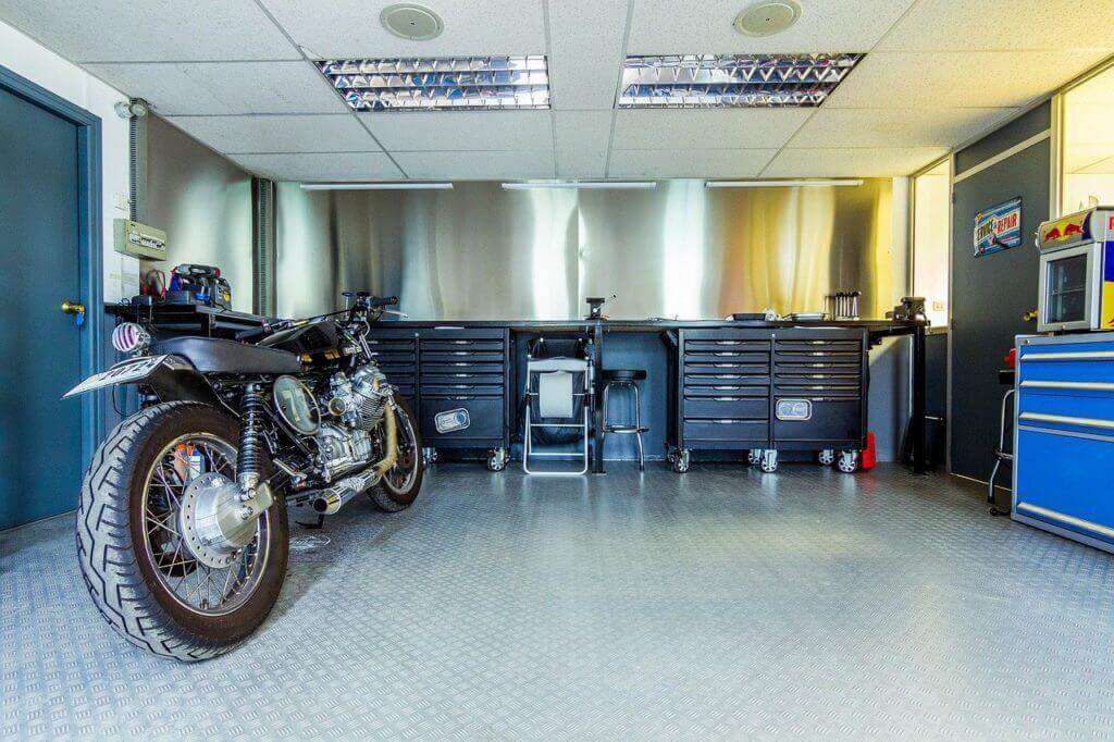 Garage remodeling workshop with custom tool storage cabinets and tile flooring