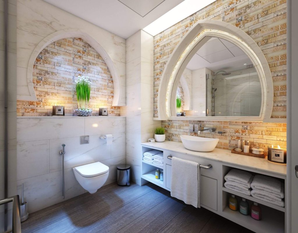 Luxury bathroom renovation with stone tile walls, vessel sink vanity and wall-mounted toilet