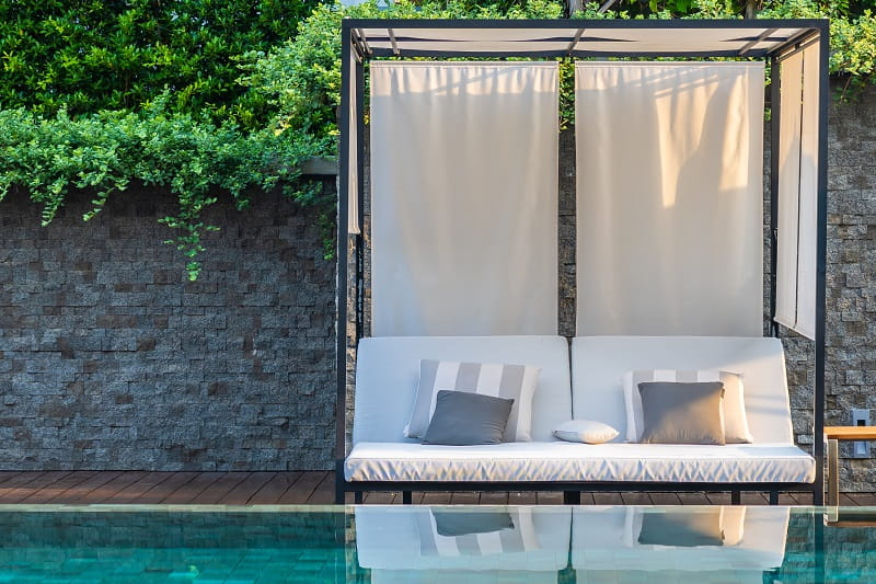 Outdoor living construction poolside cabana with built-in seating Orange County