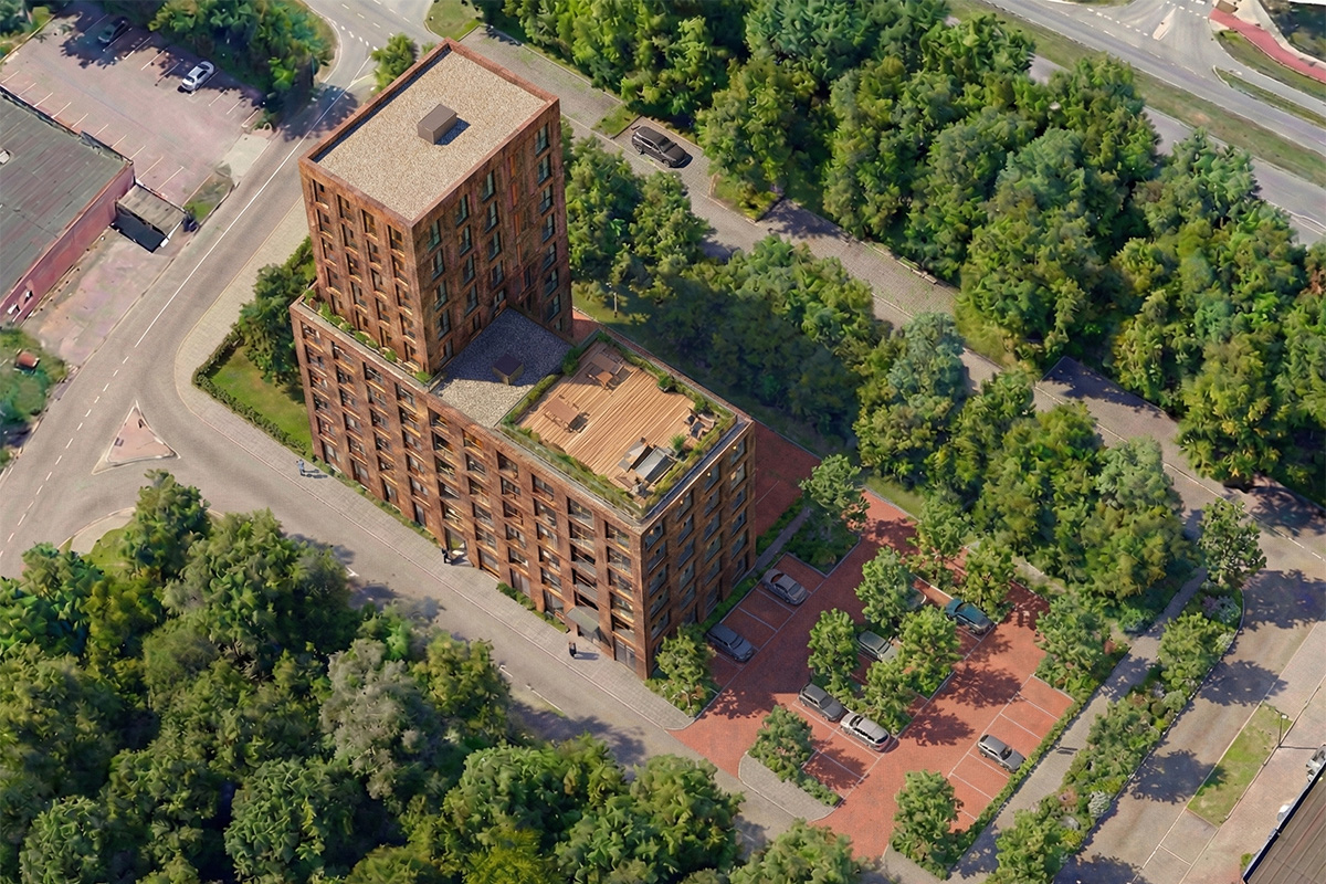 Luchtfoto van een modern appartementencomplex met een getrapte bouwvorm, dakterras, parkeergelegenheid en veel groen rondom.