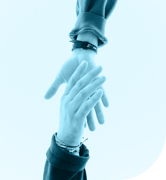 One person reaching down handing a helping hand to another person reaching up.