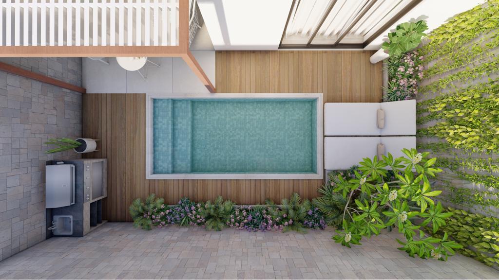 Modern pool water feature with a rectangular stone frame cascading water into a pool, surrounded by lush greenery.
