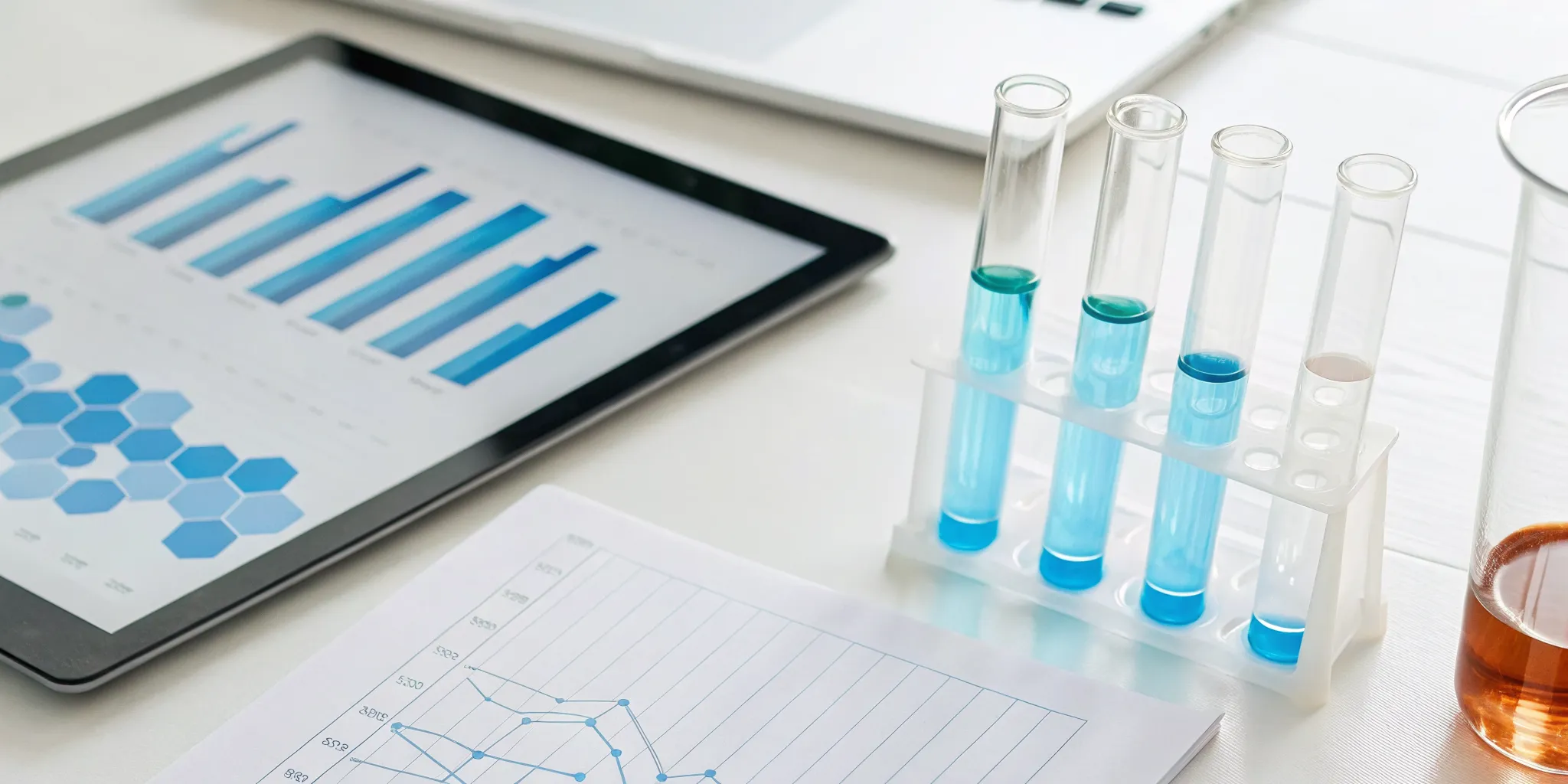 Lab results for a comprehensive chronic stress test on a tablet next to test tubes.