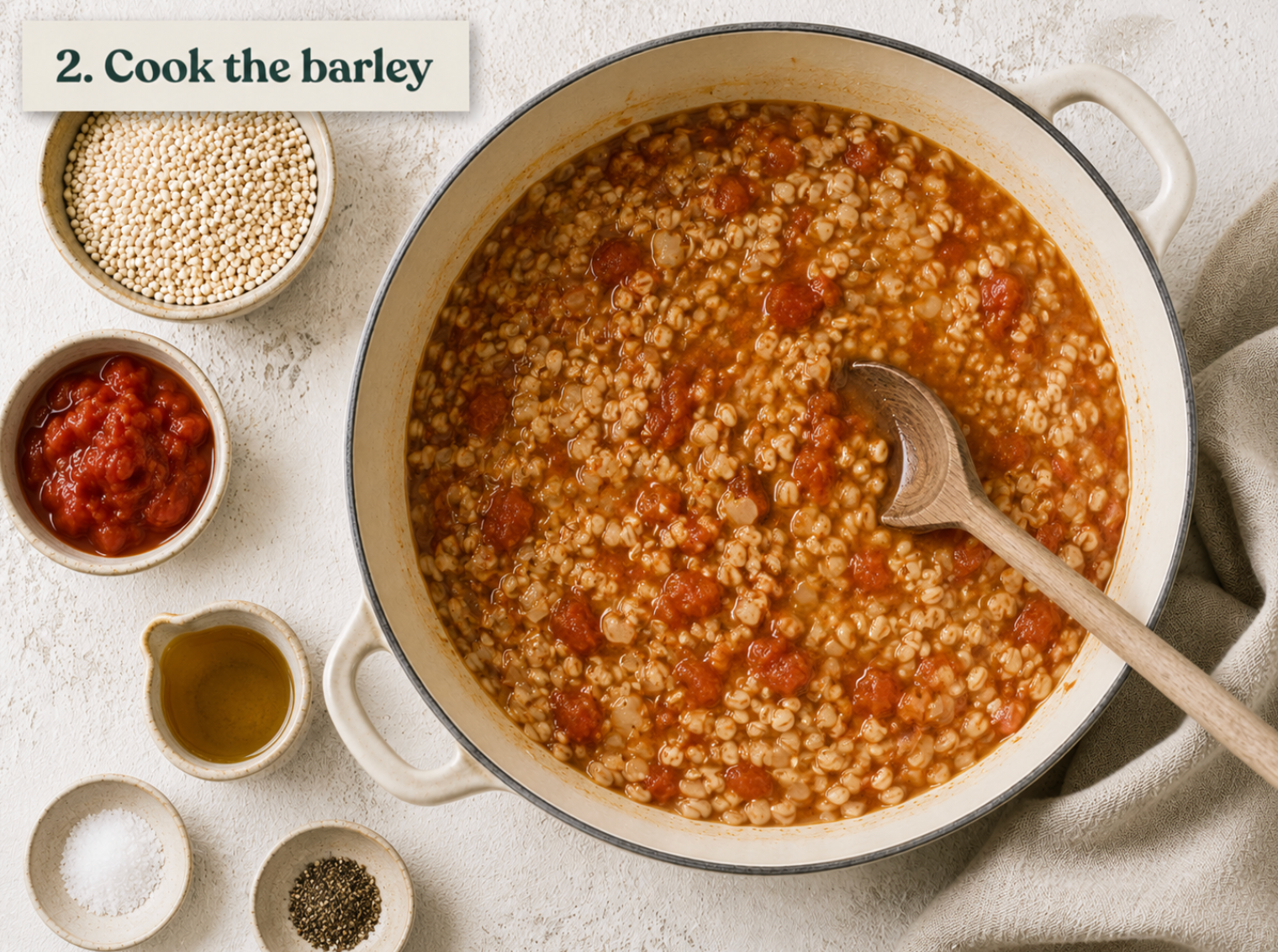 Pearl barley simmering in stock with chopped tomato until the grains are plump and tender.
