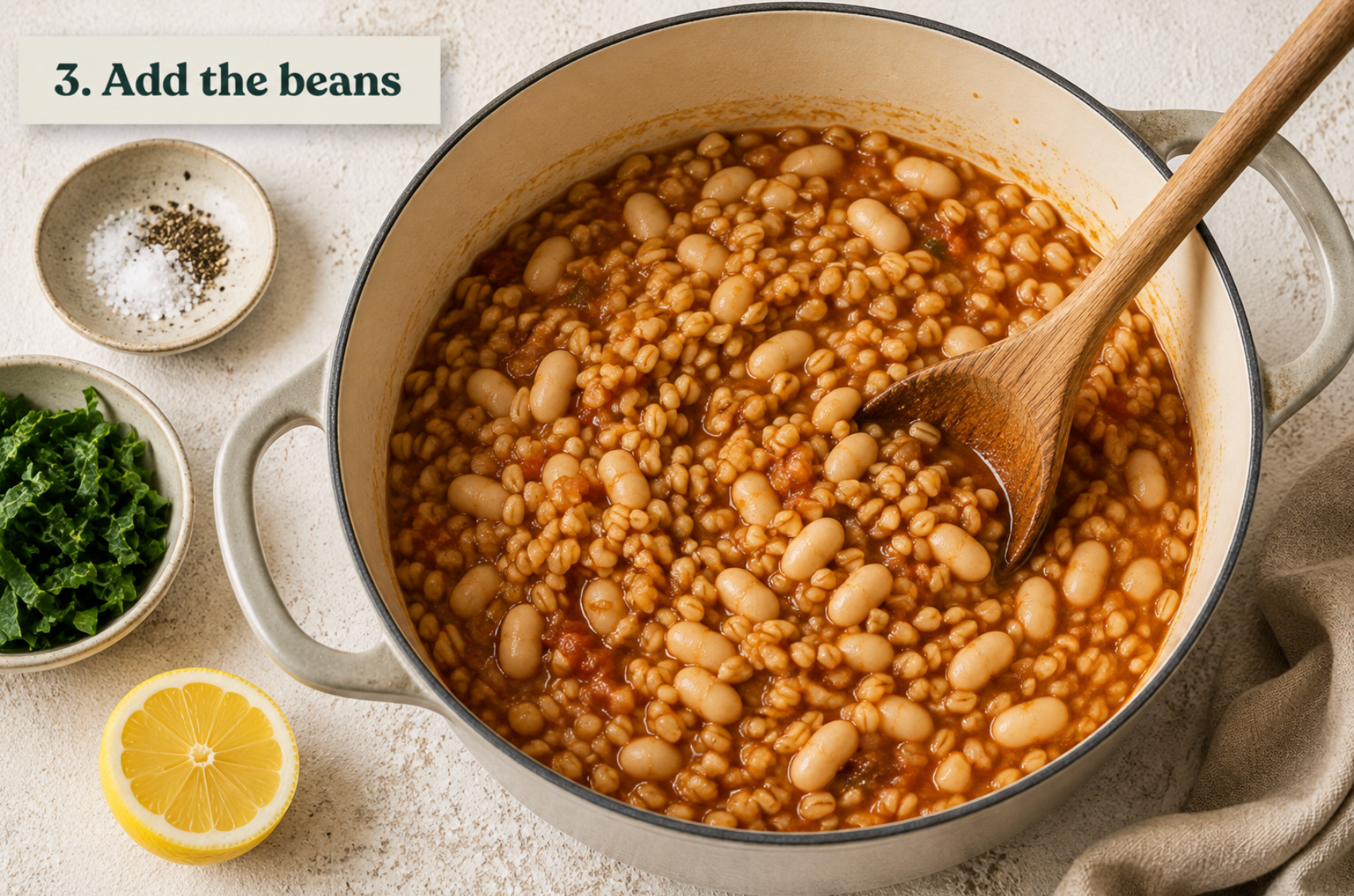 White beans stirred through the cooked barley, warming through in the pot.