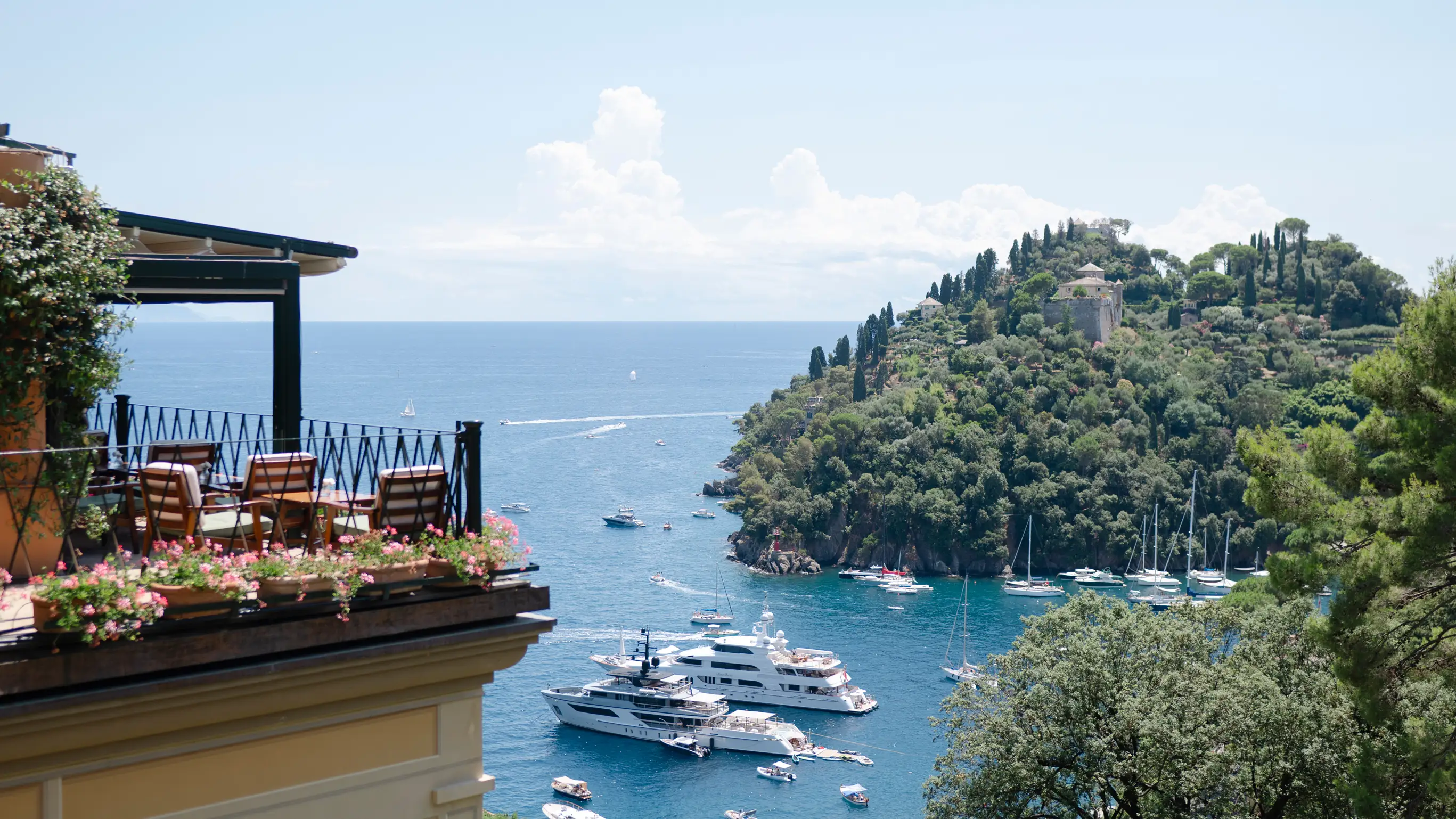 Luxurious boats anchored in beautiful Mediterranean bay with lush coastline