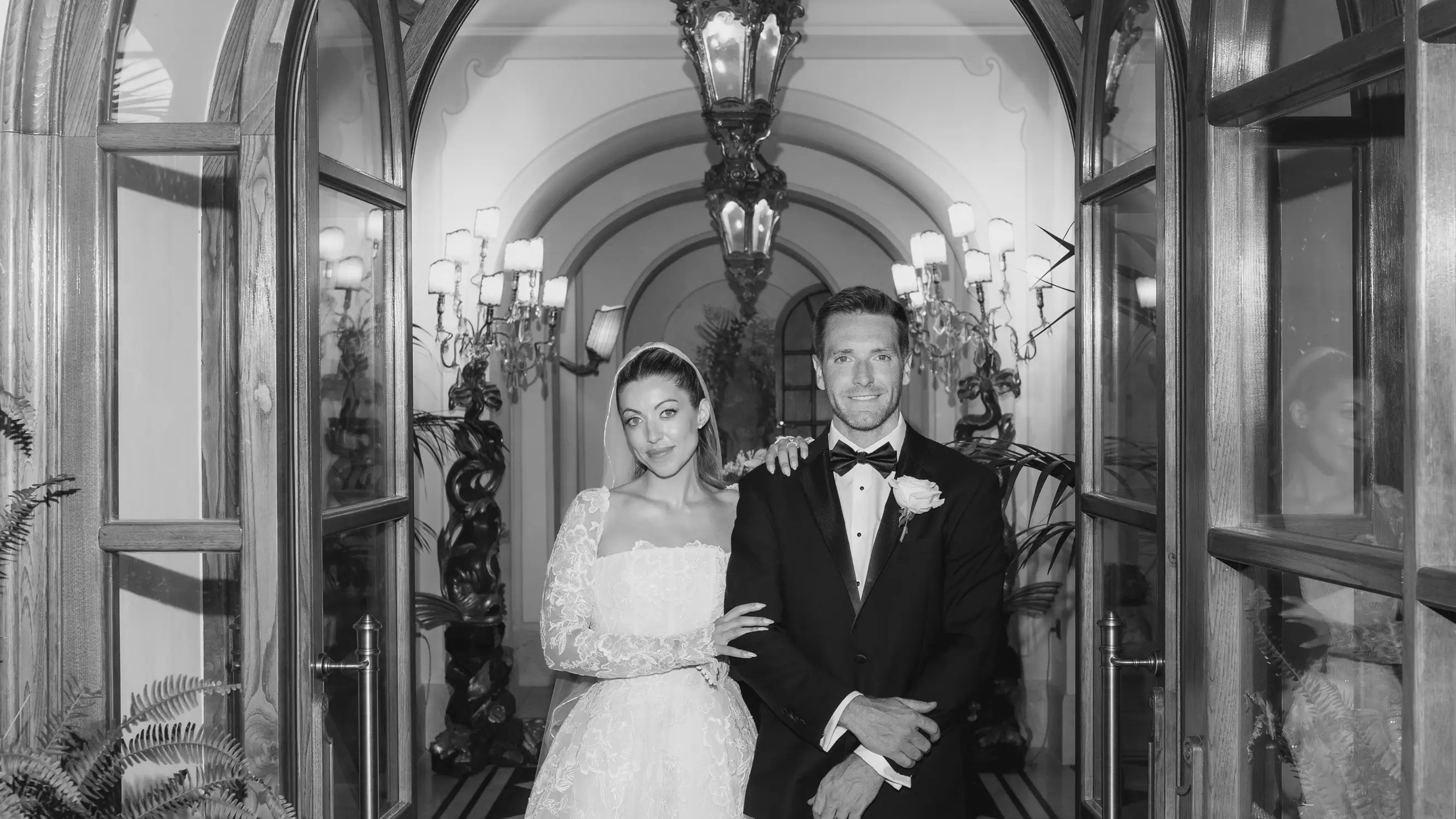 Bride and groom posing in elegant black and white wedding portrait