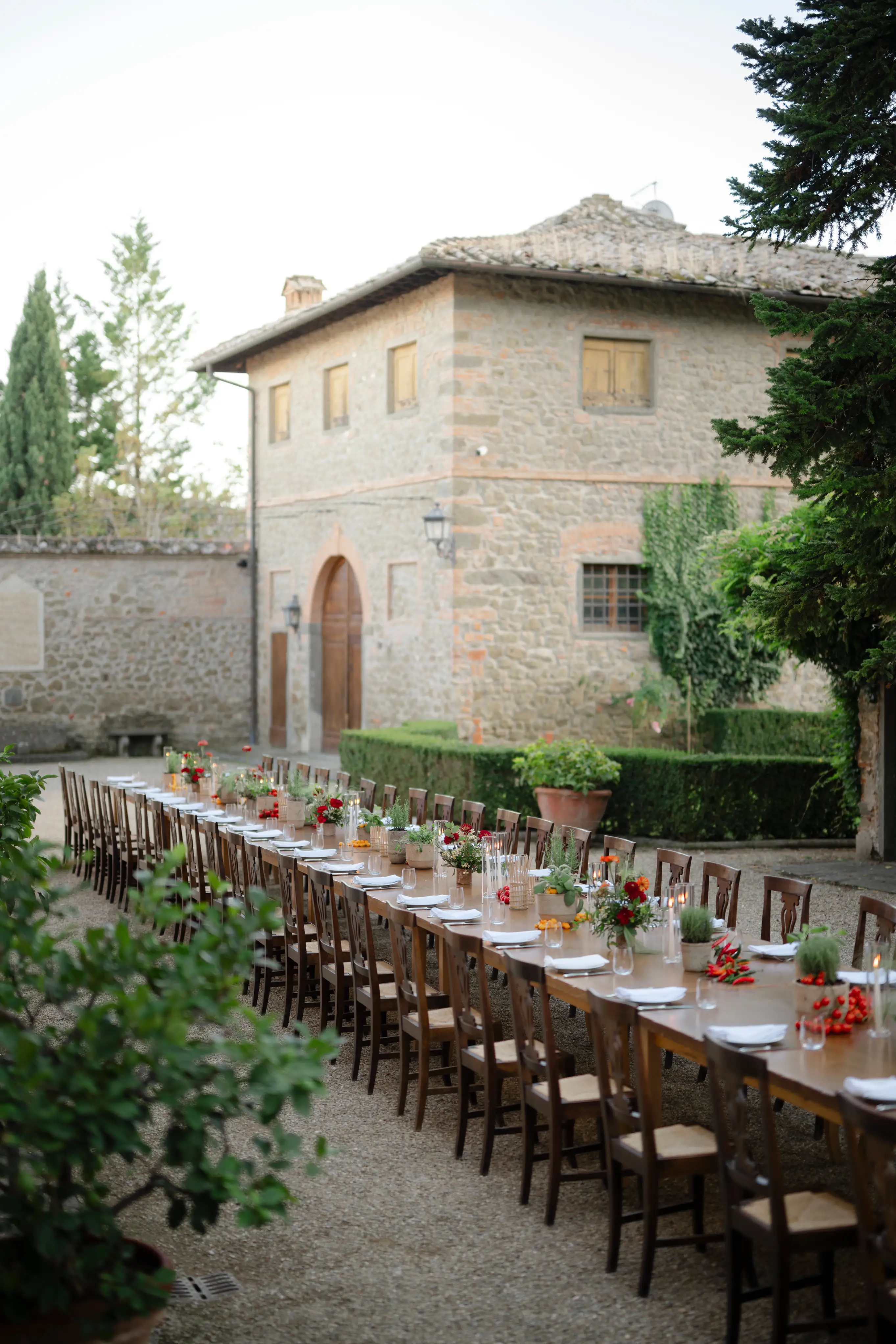 Long dining table set outdoors at rustic Italian stone villa