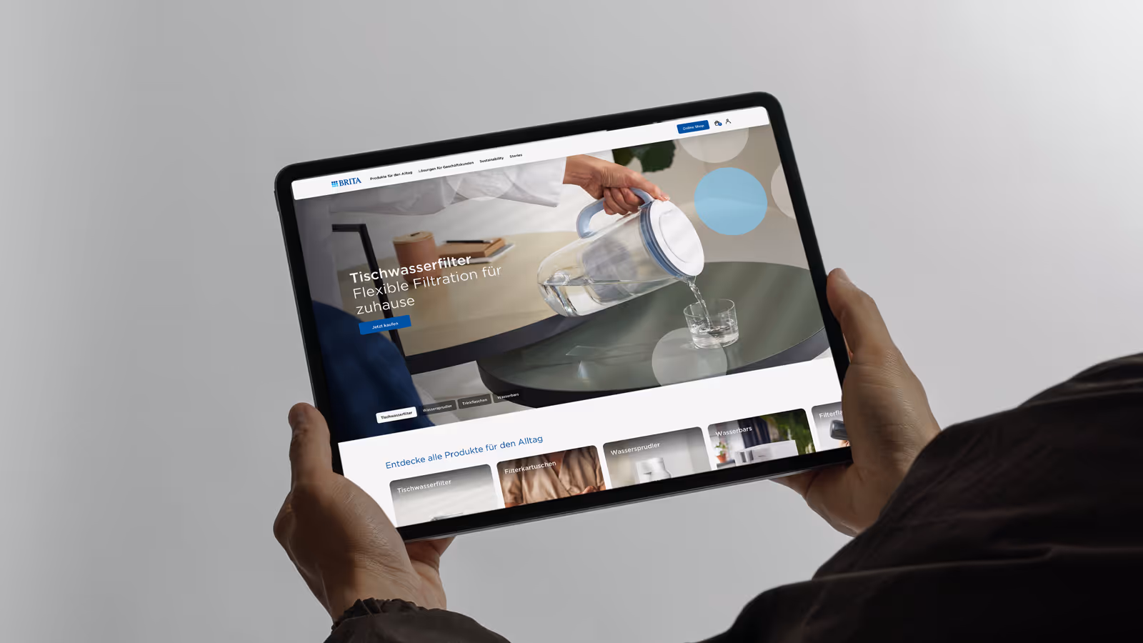 Person holding a tablet displaying the BRITA website.