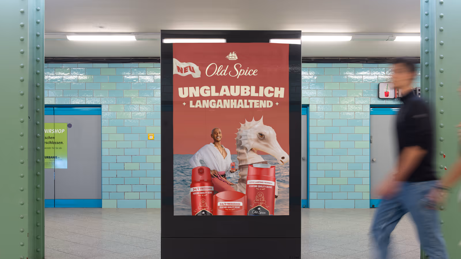 Old Spice advertisement in a subway station featuring a man sitting on a large seahorse.