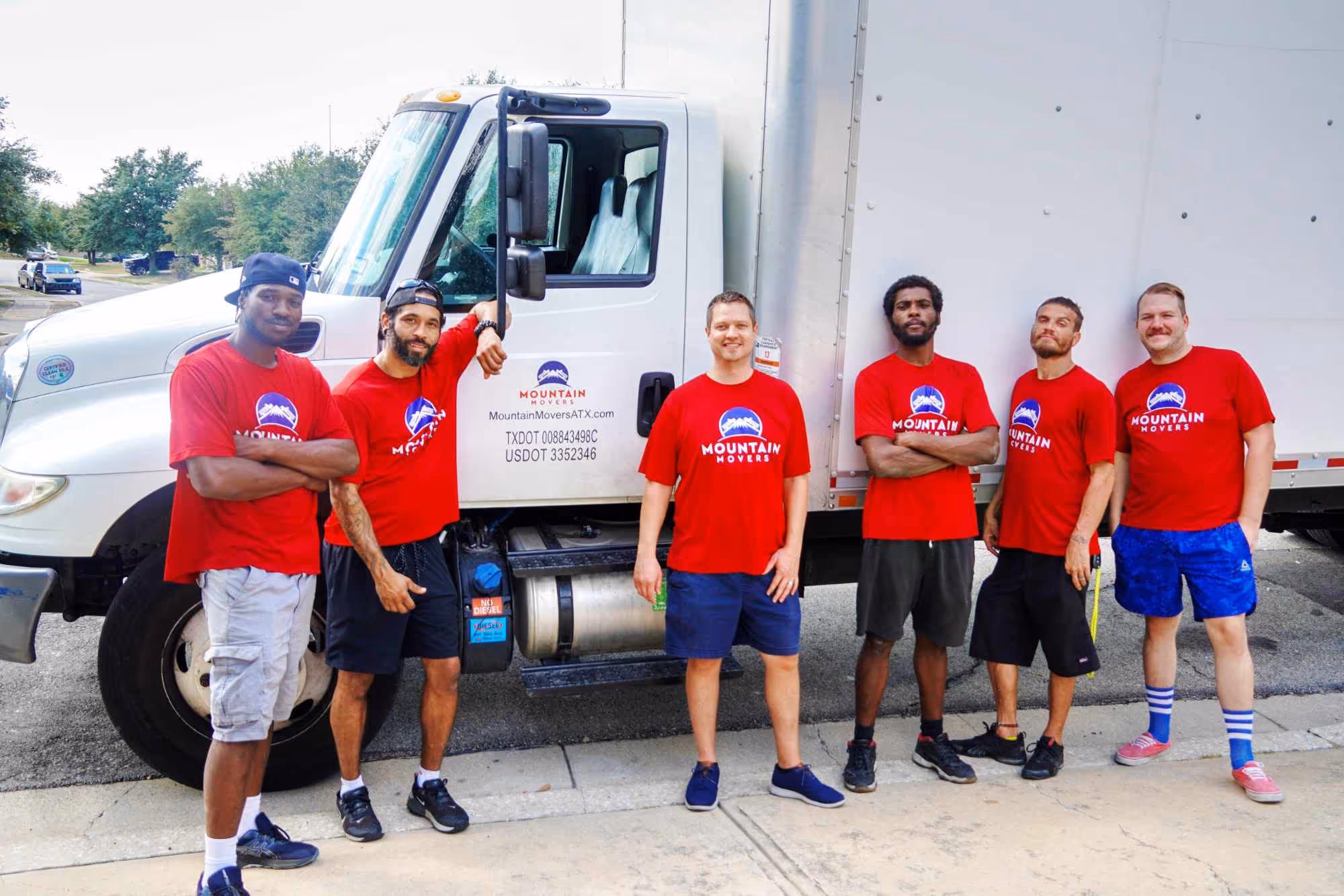 Mountain Mover team in front of their moving truck in a team photo