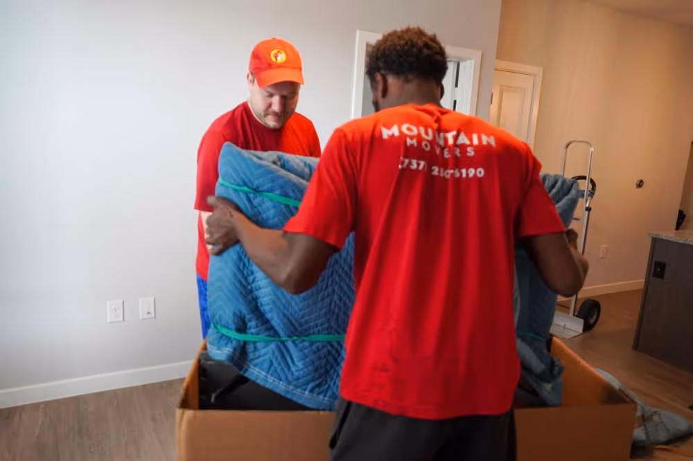 Mountain Movers Austin TX team safely wrapping and boxing furniture for secure long distance moving and relocation services.