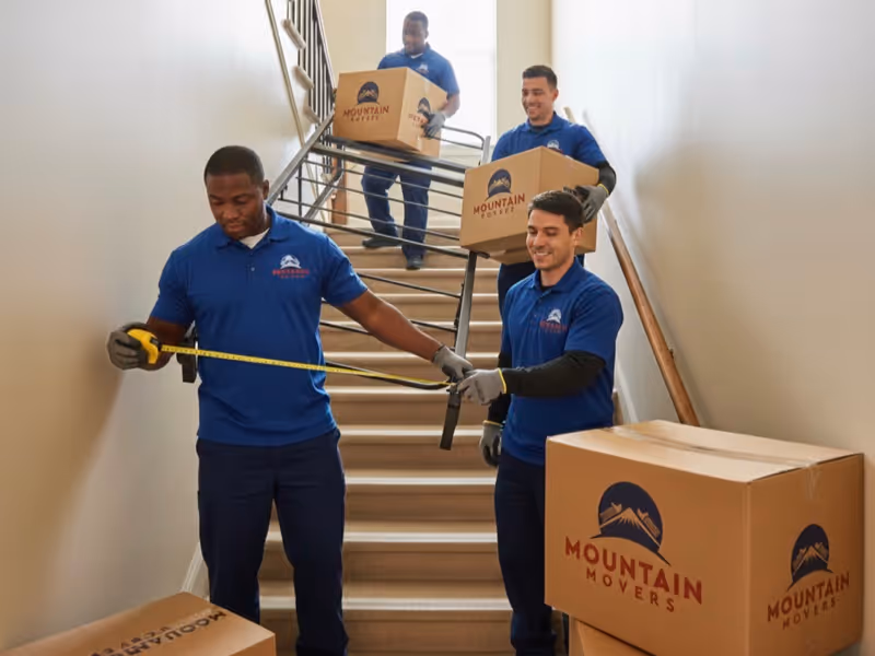 Local Moving Services in Austin TX: Mountain Movers crew safely moving boxes up stairs.