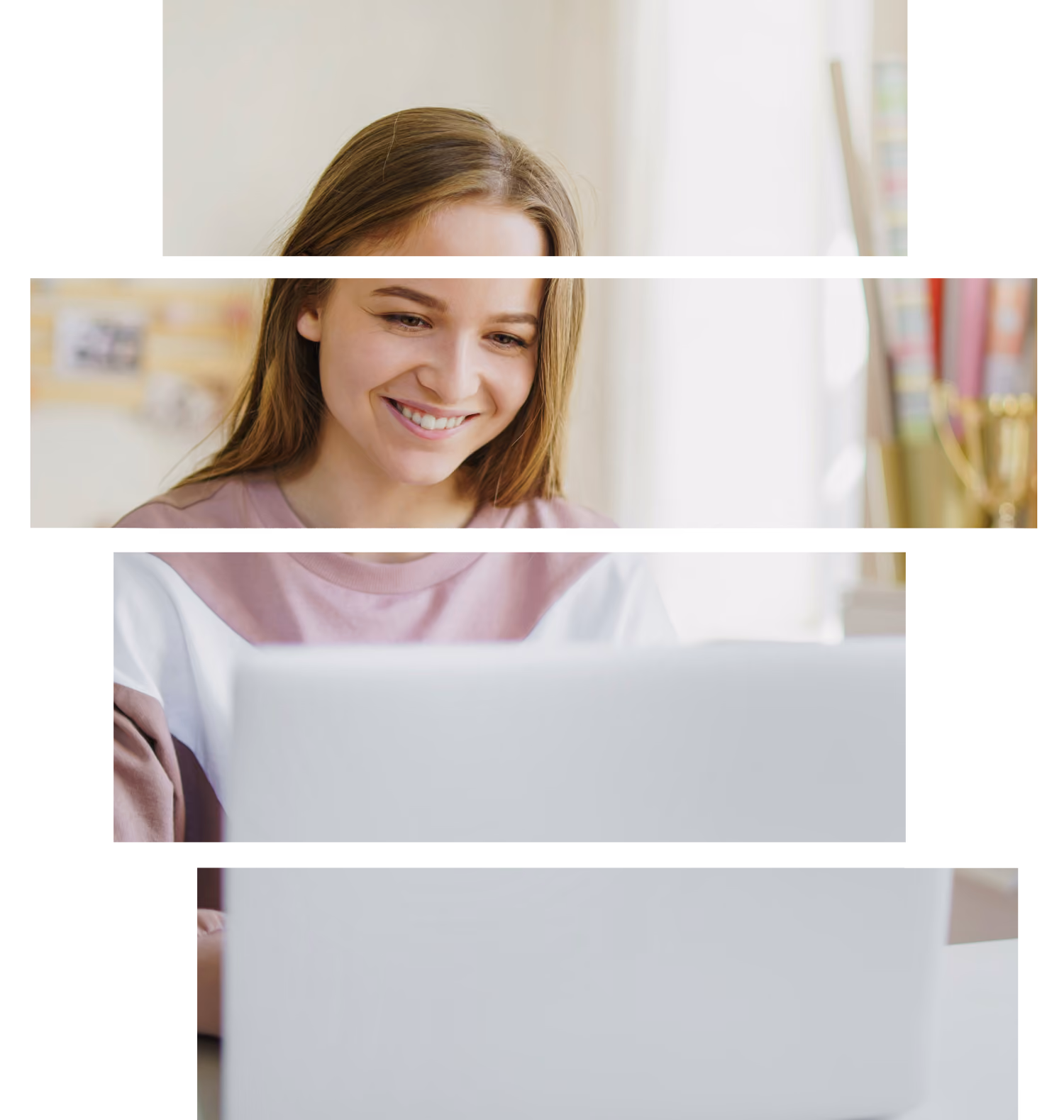A young woman smiling looking at her laptop
