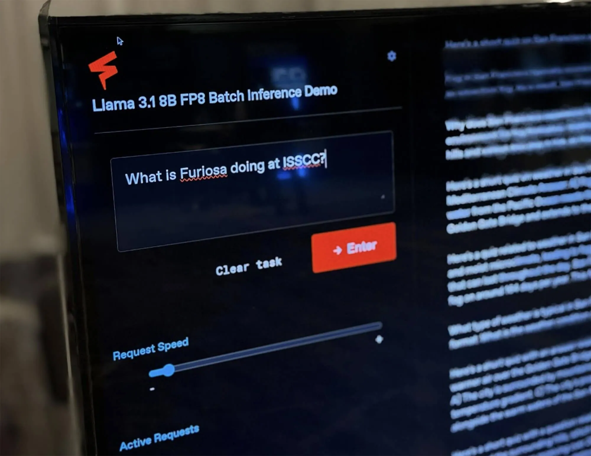 Close-up of a monitor displaying a Furiosa demo interface titled “Llama 3.1 8B FP8 Batch Inference Demo,” showing a text prompt asking “What is Furiosa doing at ISSCC?” with inference controls visible.