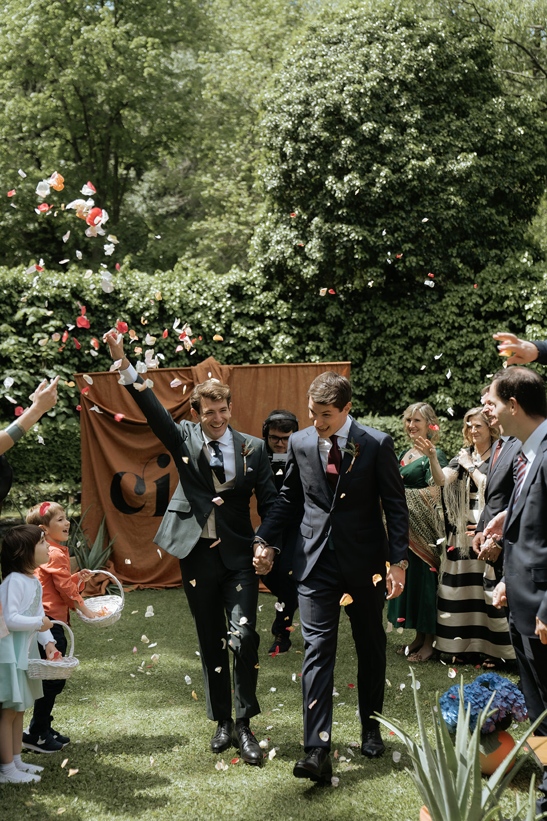Black and white photo of a couple embracing during a dance in a dimly lit venue with a bright light above.