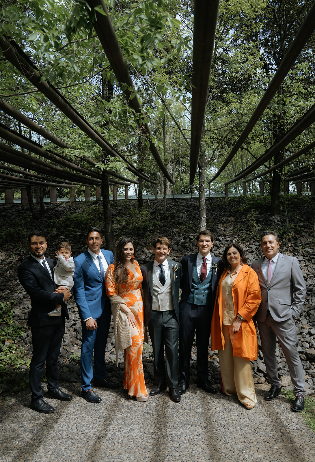 Bride and groom standing before a priest in a grand church with ornate golden altar and stained glass windows during a wedding ceremony.