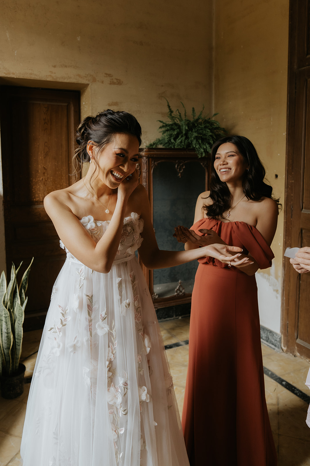 Two men in suits sharing an emotional embrace indoors.