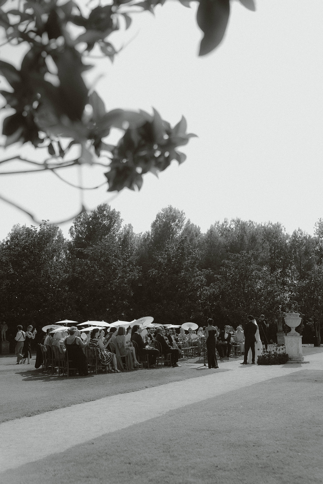Bride and groom standing before a priest in a grand church with ornate golden altar and stained glass windows during a wedding ceremony.