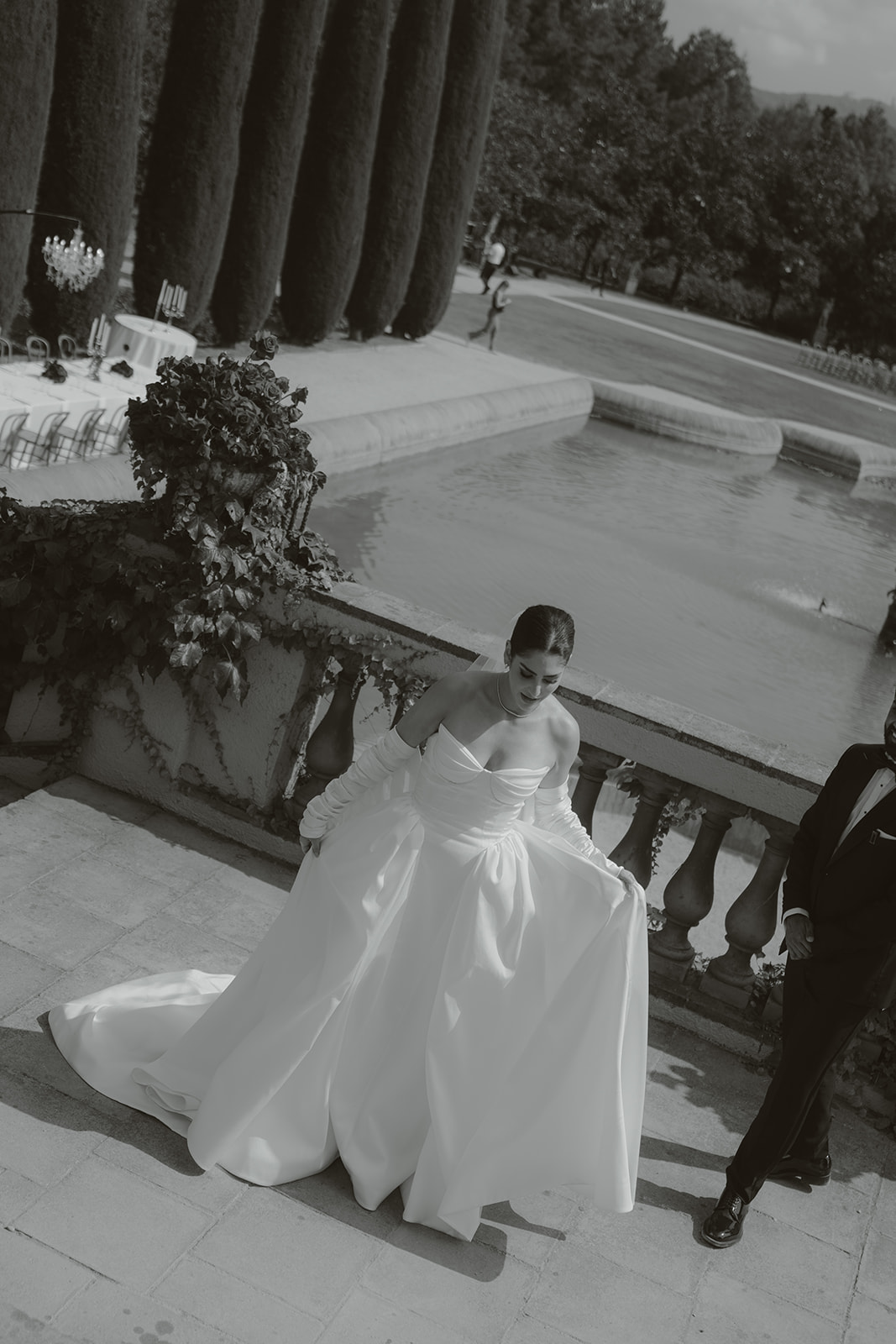 Pair of black patent leather and suede oxford dress shoes on a light marble floor.