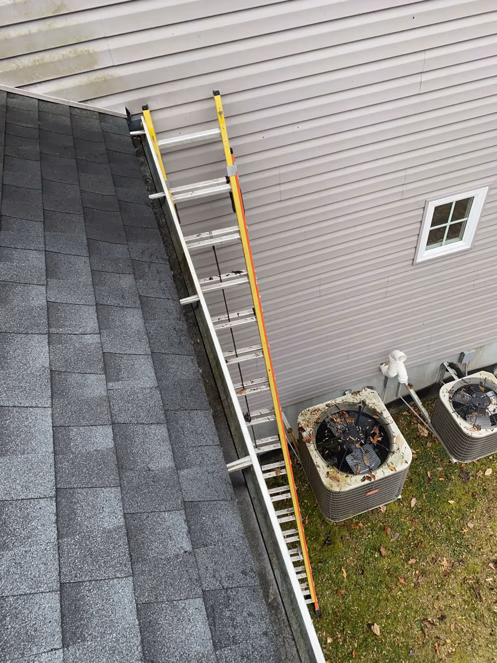 A ladder next to a clean gutter after Pollard's Dryer Vent Cleaning has provided gutter cleaning.