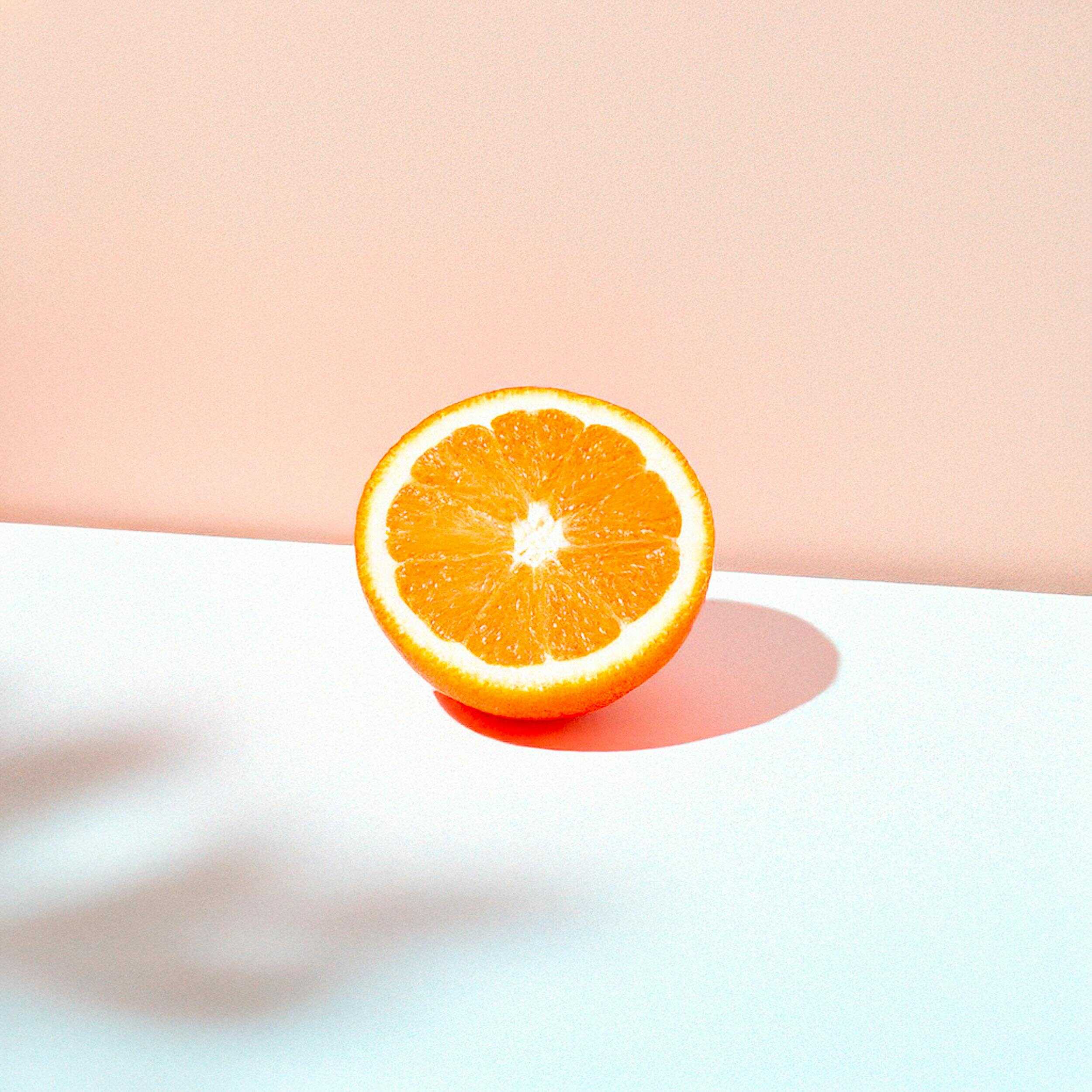 half an orange on a minimalistic background